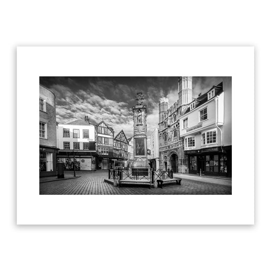 Buttermarket Square, Canterbury, Kent, England. Medieval city. Featuring the Canterbury War Memorial and Canterbury Cathedral's magnificent Christ Church Gate, Grade II listed main entrance to Cathedral precincts and scheduled ancient monument. Fine art black and white photography print for sale.