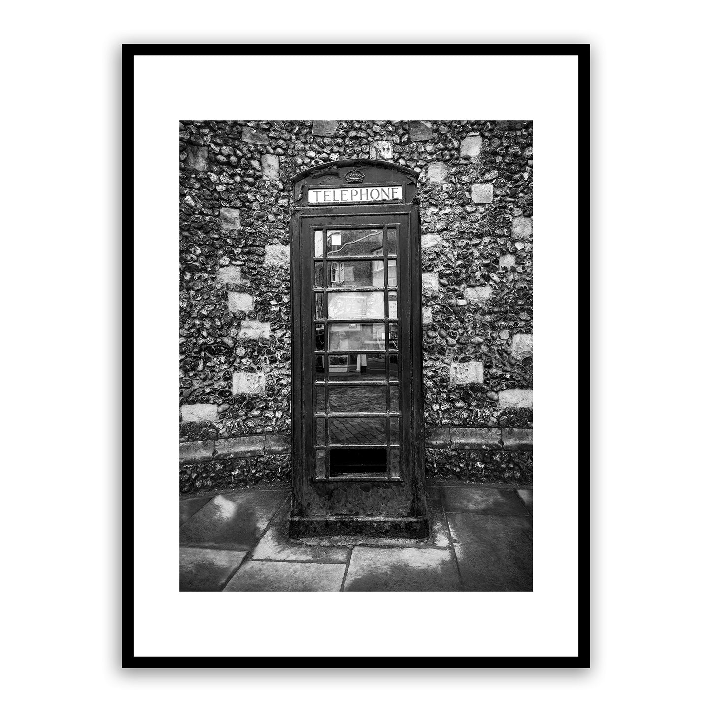 Historical telephone kiosk on the King's Mile, Canterbury, Kent, England. Designed in 1935 by Sir Gilbert Scott, introduced in 1936 to mark the jubilee of George V. The crown appearing above the door was the traditional Tudor crown. These cherished phone boxes in Canterbury are actually considered listed buildings! Fine art black and white photography print for sale.